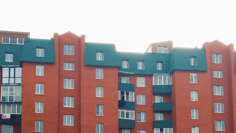 Image of brick-colored apartment building