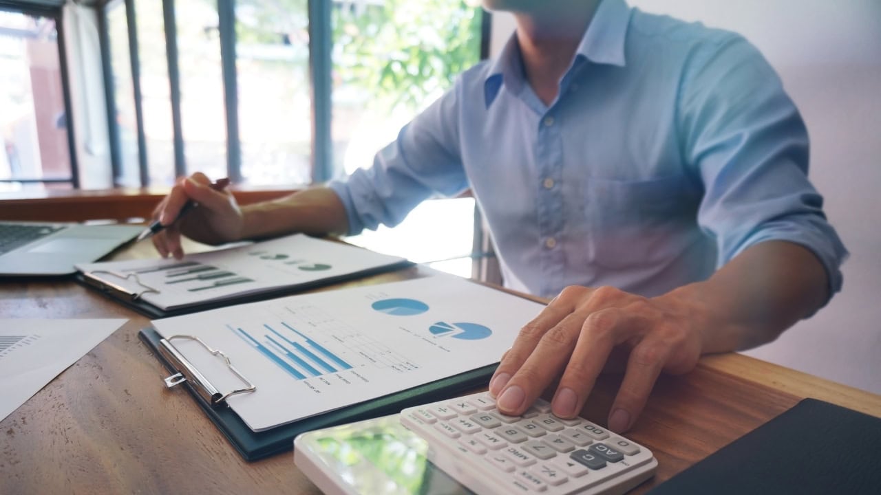 A man sitting down with financial papers in front of him