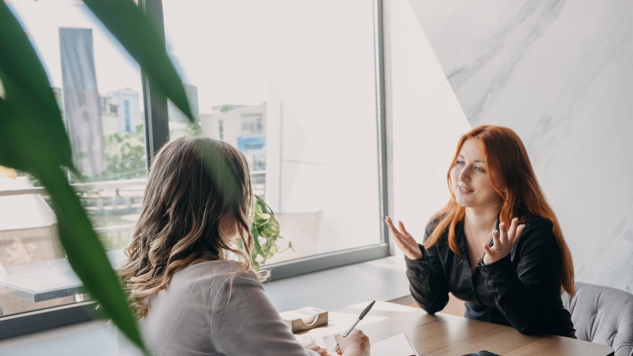 A woman is talking to a client 