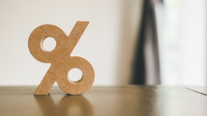 A picture of a wooden percentage sign on a wooden table