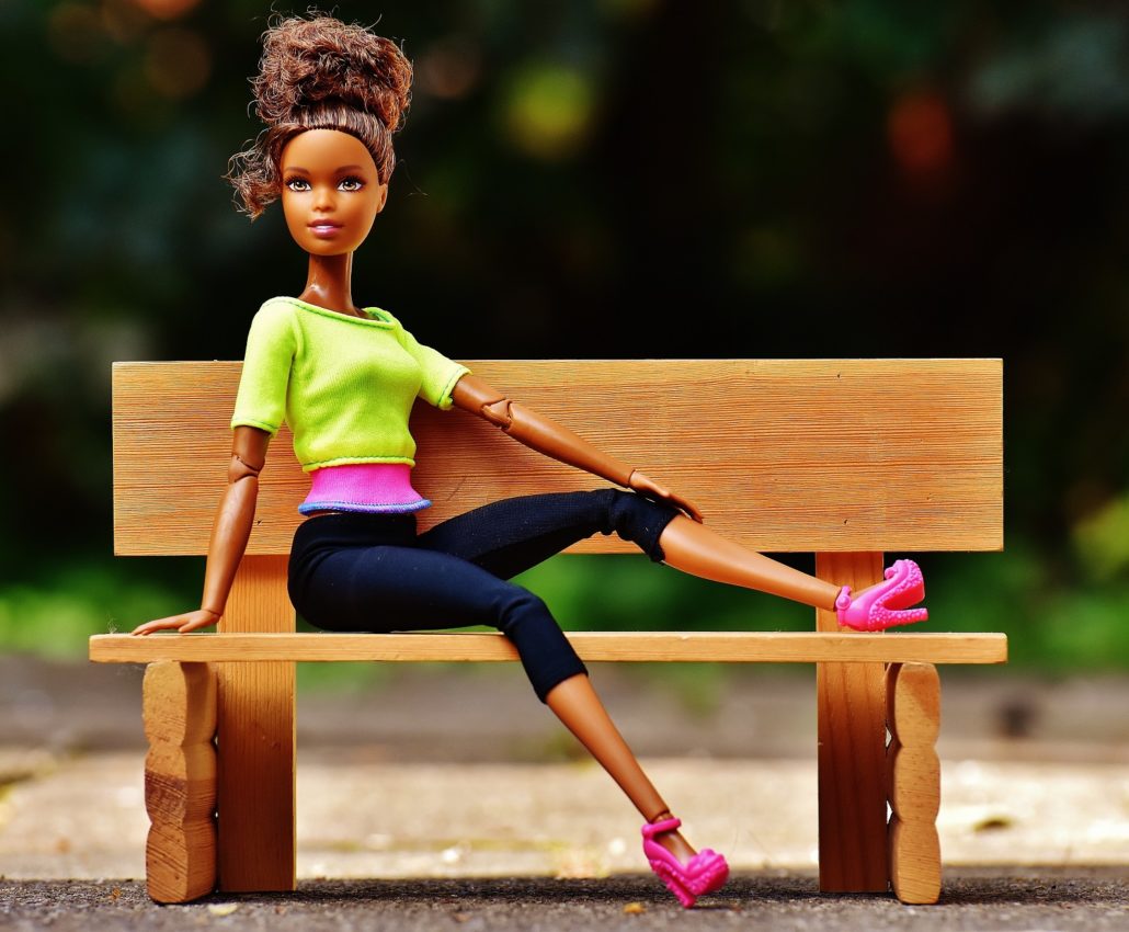 Photo of Mattell's barbie doll posed on a bench in a like green shirt and navy blue pants. Mattel and Bratz were in a heated lawsuit over copyright infringement.