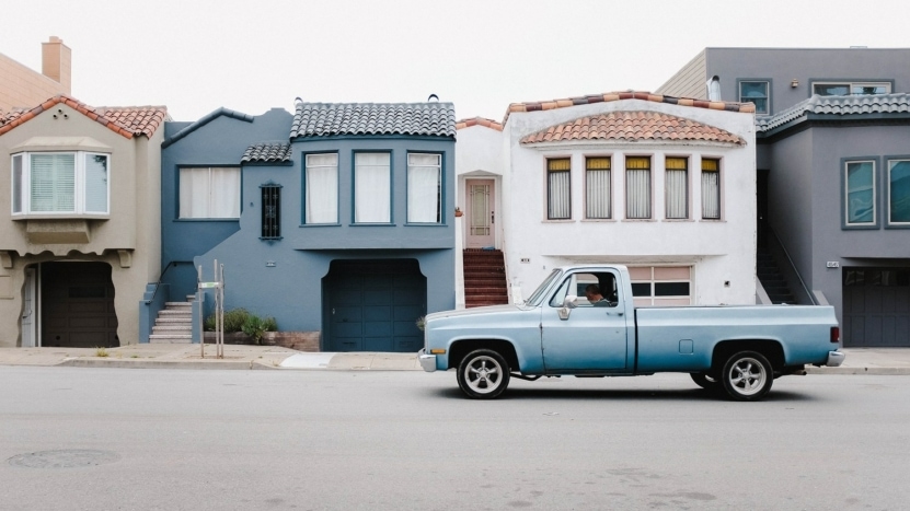 blue-truck-in-front-of-houses