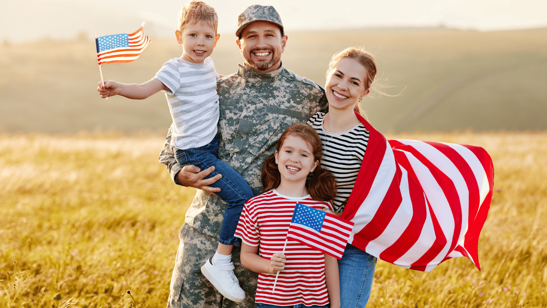 Family smiling at camera with American flags