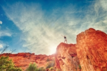 Woman on top of red cliffs