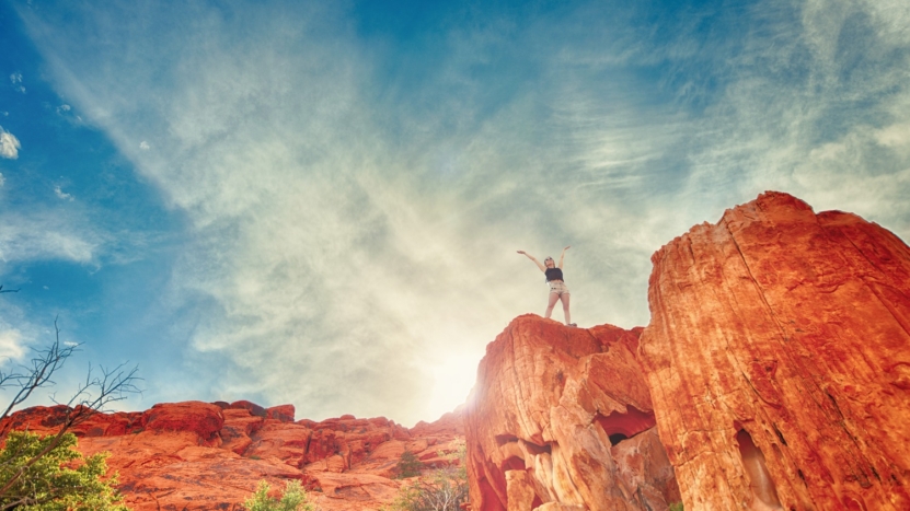 Woman on top of red cliffs