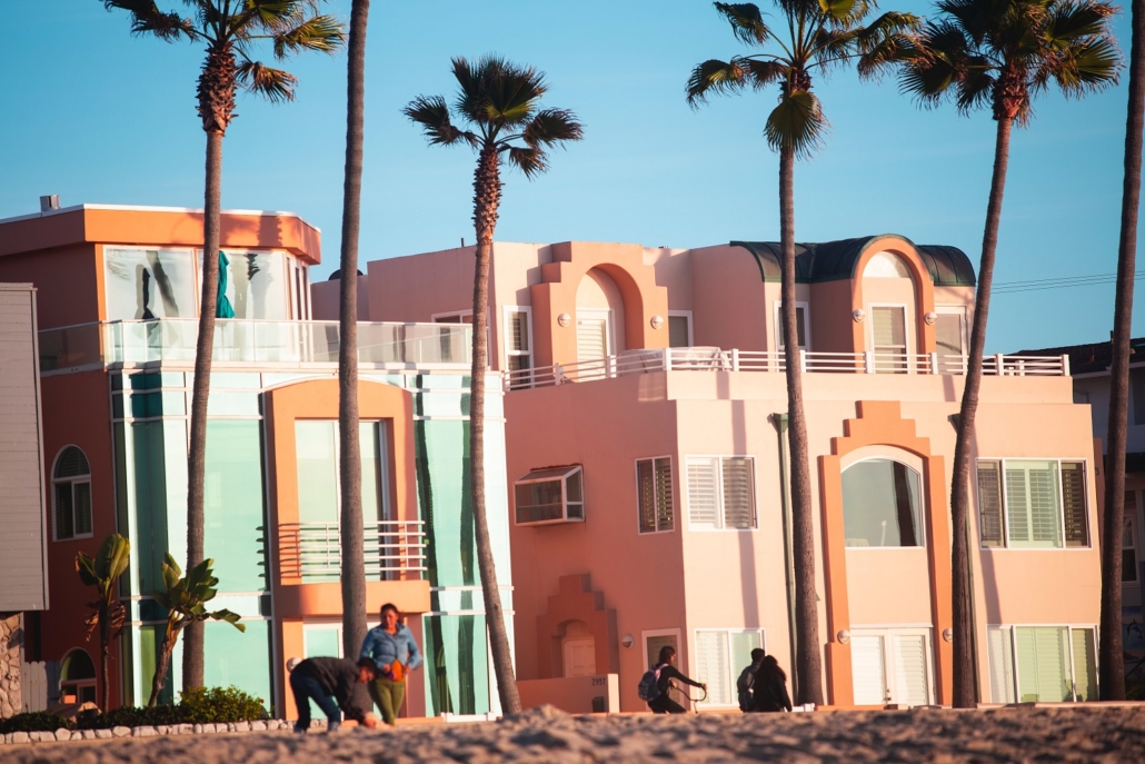 Art Deco style building by the beach in blue and salmon pastel colors. Homeowners should consider refinancing now!