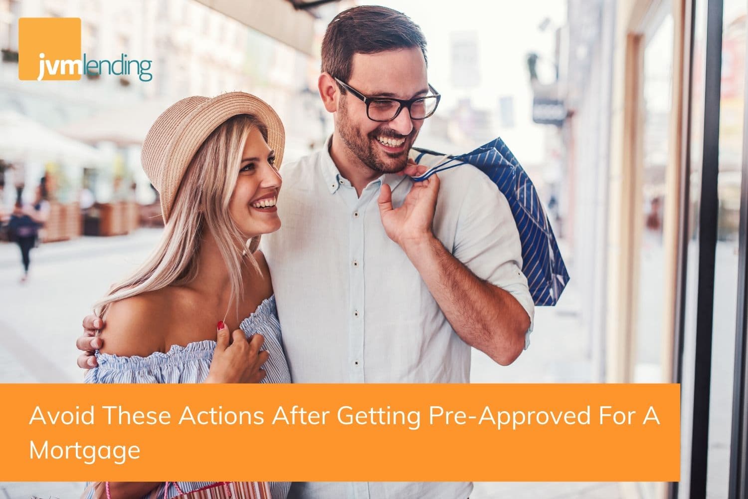 a young couple is out shopping together downtown. Homebuyers should not take on new debt from increasing credit card balances after getting pre-approved for a mortgage..