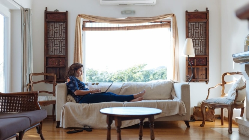Women sitting on couch with open window