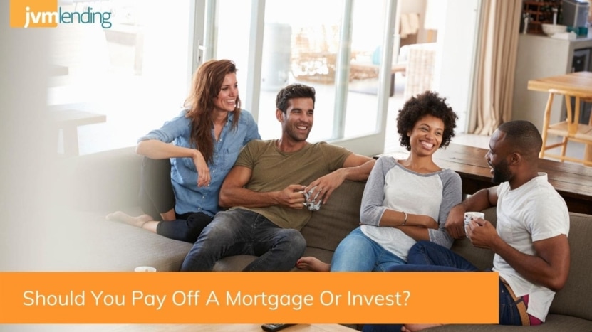 A group of four friends sitting in a living room discussing whether you should pay off a mortgage or invest