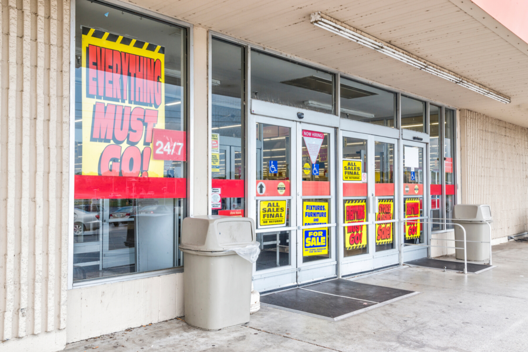 Business that fail to innovate often get killed in the future. This storefront of a business is covered in signs advertising closing sales because they are shutting down.