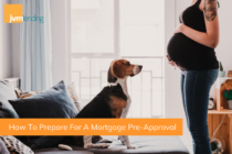A young pregnant woman is in the living room of her new condo with her dog that she purchased after getting pre-approved for a mortgage.