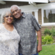 Retired African couple embracing each other on yard