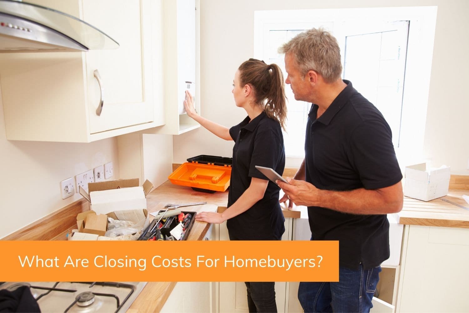 A young homebuyer and home inspector look at the kitchen and asses additional repair costs that will need to be added to the total closing costs.