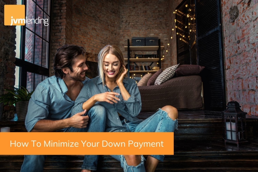 A young couple sits in their new home that they purchased with less than 20% down. You can minimize your down payment using these simple tips when buying a home.