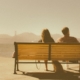 A couple sits on a bench overlooking the Golden Gate Bridge as they talk about finalizing their divorce.