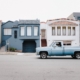 Old blue truck parked in front of san francisco houses