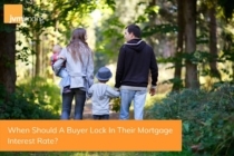 A family walks together on a trail and discusses when is the best time for them to lock in a mortgage interest rate.