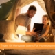 A father spends time with his daughter in play tent in the living room of his new home that he purchased after researching different types of mortgage loans.