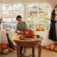 A homeowner carves a pumpkin in her kitchen on the table. She purchased her home and had to deal with setting up her payments with the new loan servicer.