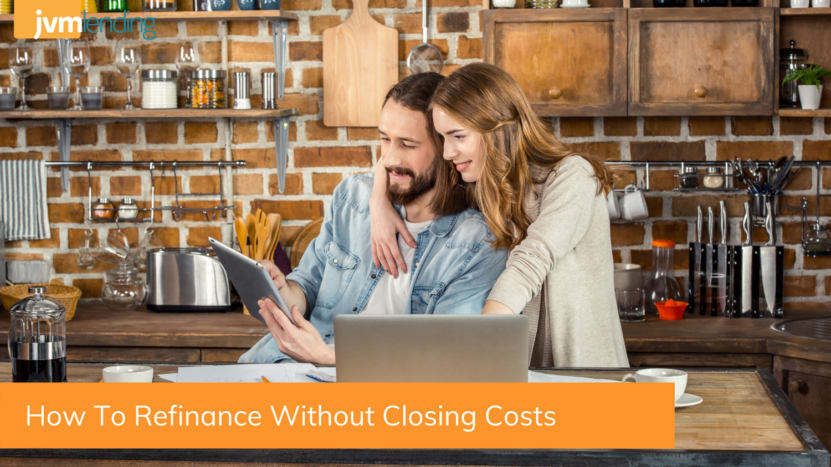 A young couple look at a computer together and research different refinance options for their new home like no cost refinance loans and no money out of pocket refinances.