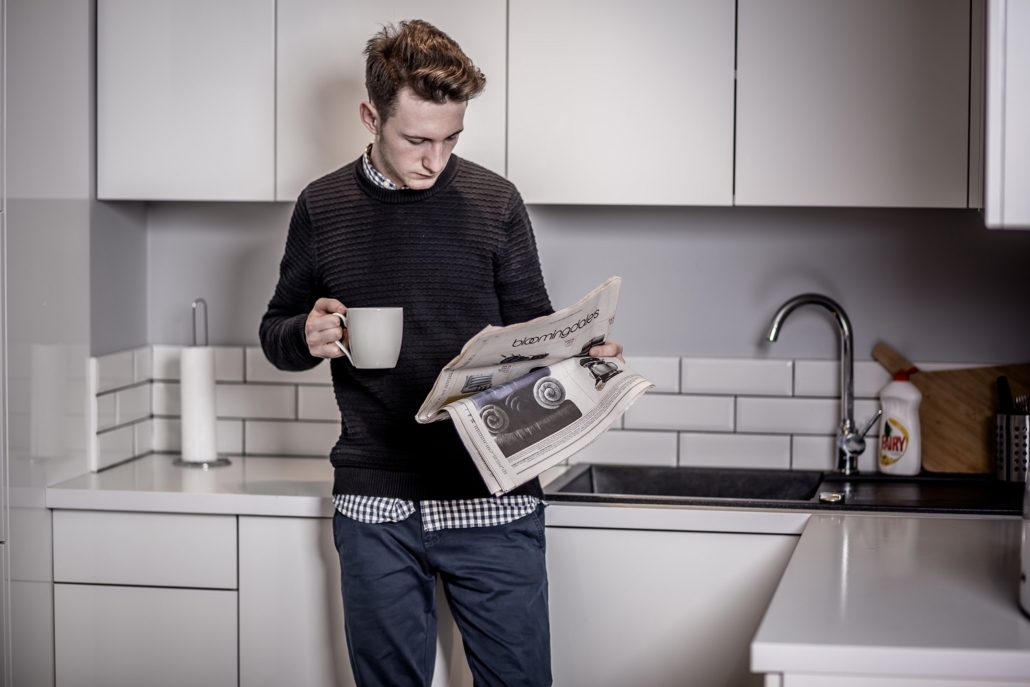 A young man reads a newspaper in his kitchen with a cup of coffee in hand. Consumers of information should be wary of experts - because they can be wrong, and are often.