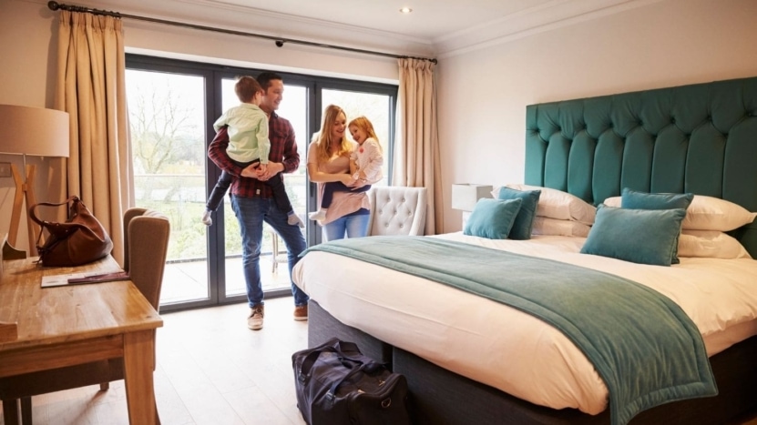 Family of four arriving at their Airbnb rental house for vacation