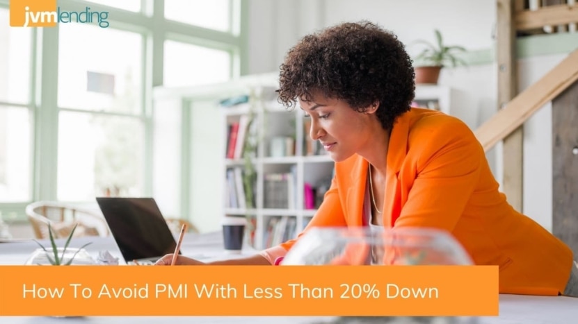 a woman looks at a computer to research PRM and a down payment of less than 20%