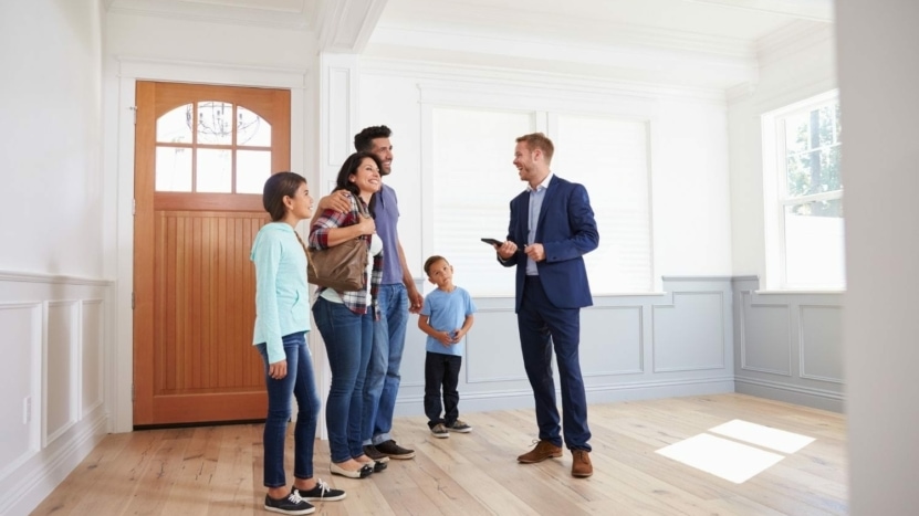 Realtor showing a house to a family of four