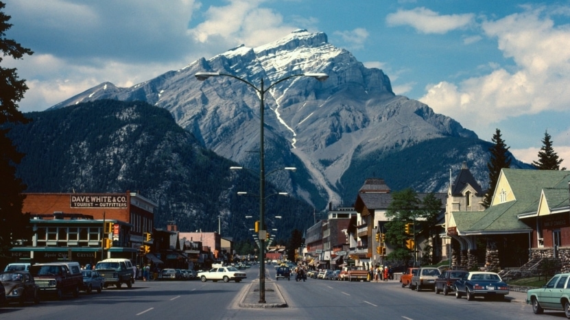 A town in the 1908s with a picturesque view of the mountains has many homes and businesses that were affected by inflation which impact their nominal and real rates for any loans used to purchase property.