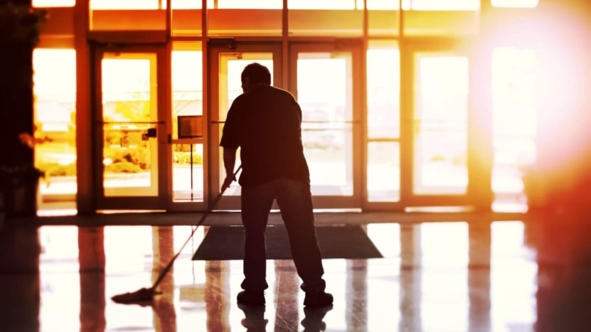 Silhouette of a janitor mopping the floor