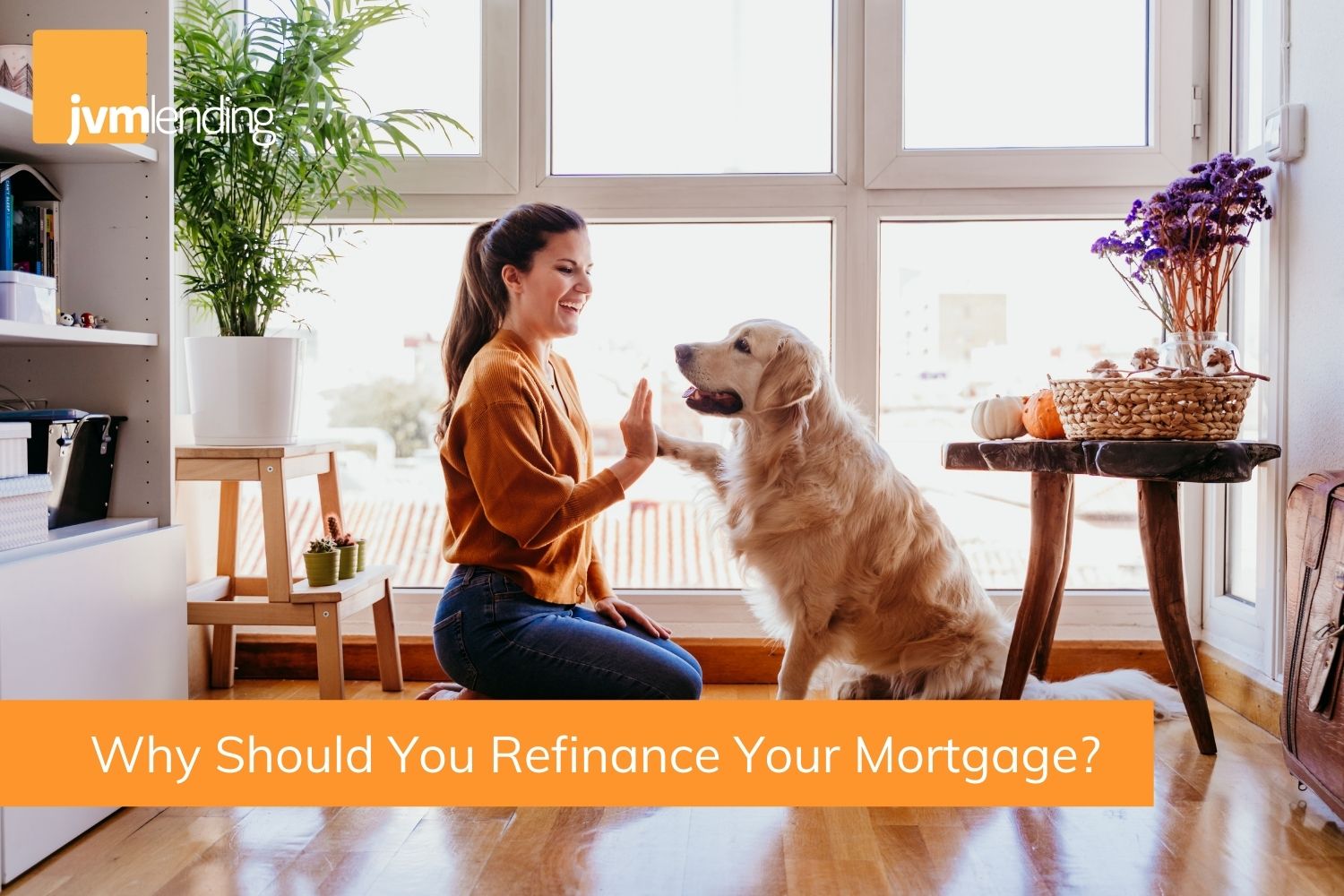 A happy woman high fives with her Golden Retriever dog because she just found out she should and can refinance her mortgage.