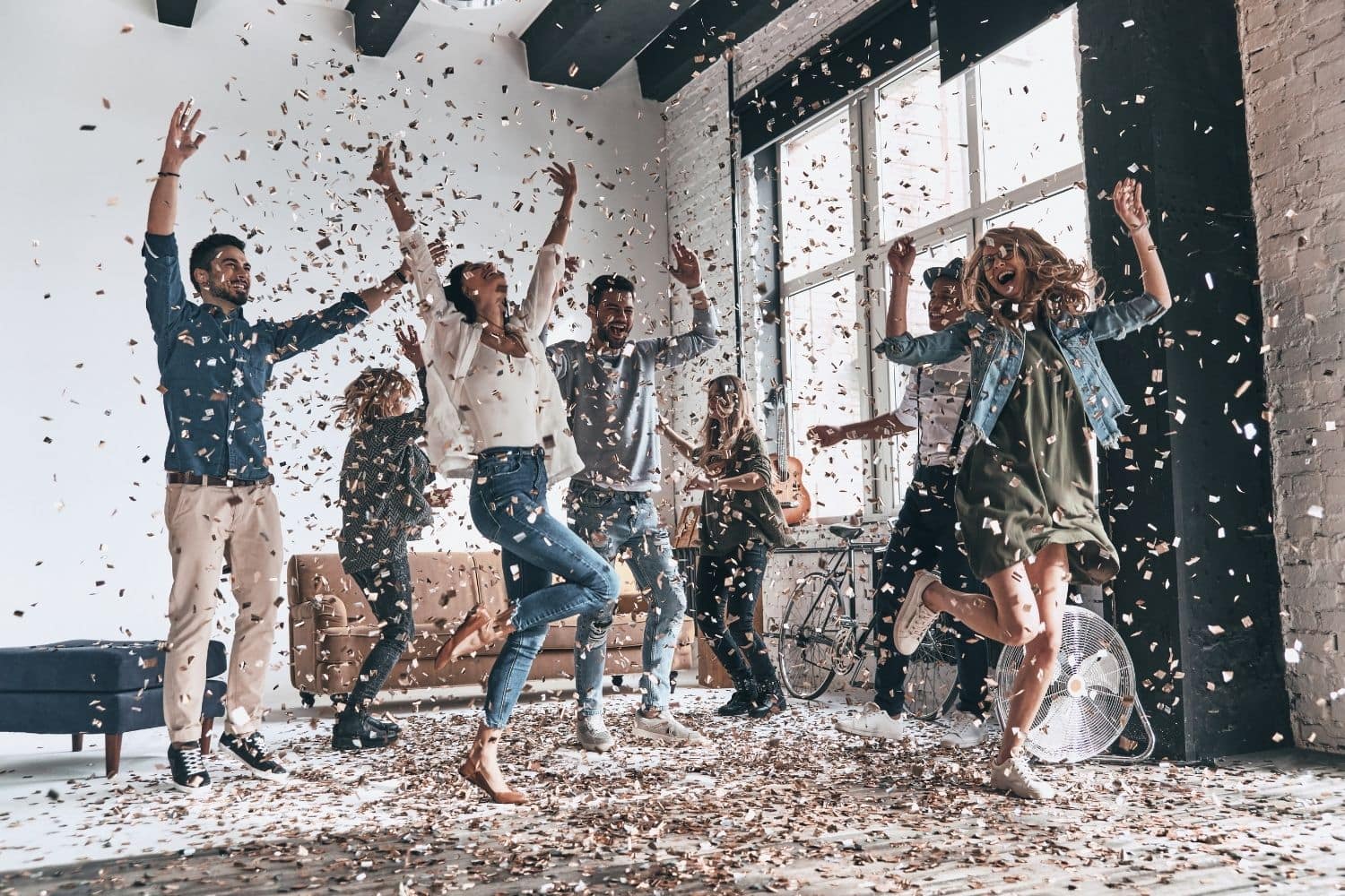 Coworkers celebrate with confetti in the office
