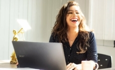 A woman smiles after seeing how much lower her interest rate when she works with a 