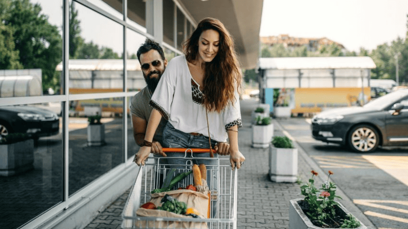 Young couple with grocery cart