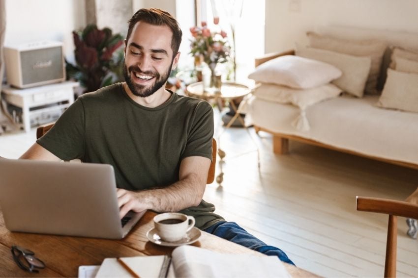 man sitting at home looks up interest-only loans on his laptop