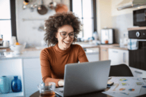 Women sitting in the kitchen with a laptop