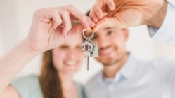 A couple holding a key to their new home