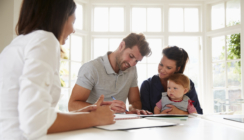 Family With Baby Meeting Financial Advisor At Home