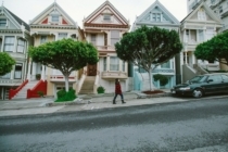 Woman walking up steep house-lined San Francisco street