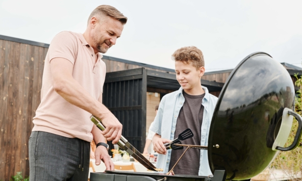 Father and son barbequing in Frisco, Texas