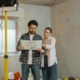 Couple Looking at the Blueprint for their home renovation