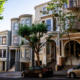 Cars parked near mansions in San Francisco residential district in sunlight