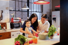A Family Preparing Dinner Together In Their Modern Kitchen