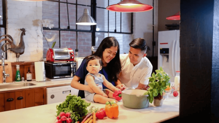 A Family Preparing Dinner Together In Their Modern Kitchen