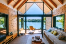 A scenic view from inside of weekend cottage by the riverside