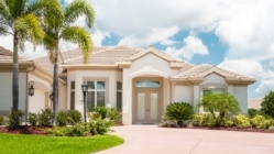 A nice home in Florida with palm trees and landscaping