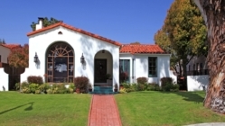 A house in San Jose, California with red tile roof and brick walkway