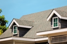 Roof shingles with house on top of the house. dark asphalt tiles on the roof background on afternoon time. dark asphalt tiles on the roof background
