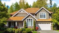 A nice home with landscaping and trees in the front yard