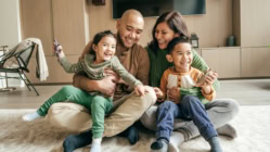 A family sitting on the floor together in their home's living room